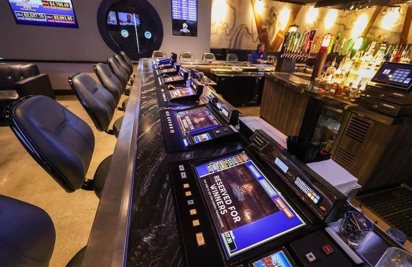 Tabletop games line the bar at Flowing Tide Pub in northwest Las Vegas on Wednesday, Feb. 22, 2023. (Jeff Scheid/The Nevada Independent)