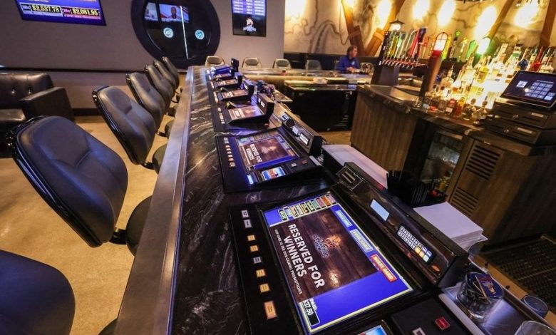 Tabletop games line the bar at Flowing Tide Pub in northwest Las Vegas on Wednesday, Feb. 22, 2023. (Jeff Scheid/The Nevada Independent)