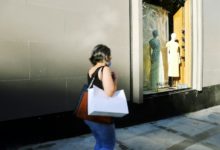 woman in white shirt and blue denim jeans standing in front of mirror