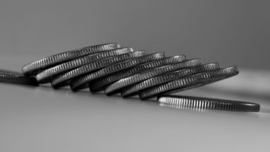 a stack of silver coins sitting on top of a table