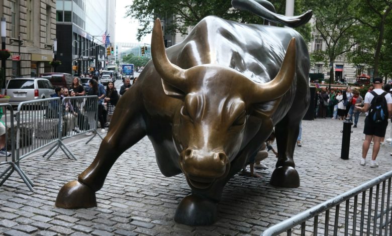 a statue of a bull on a brick street