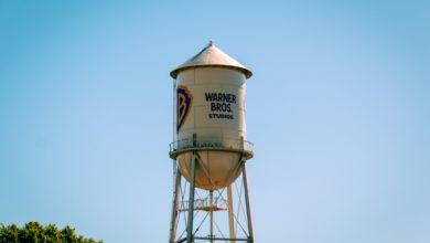 The warner bros. water tower against a blue sky.