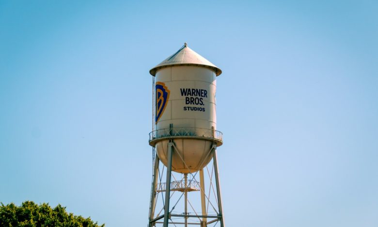 The warner bros. water tower against a blue sky.