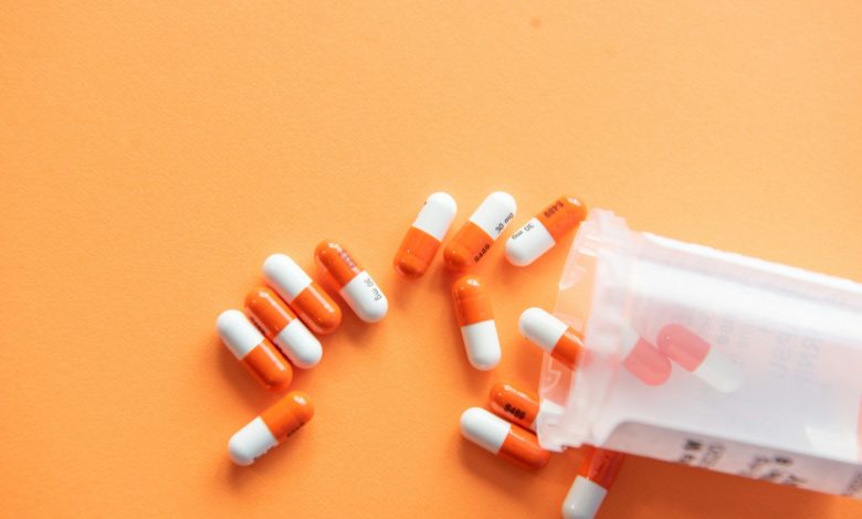 orange and white medication pill