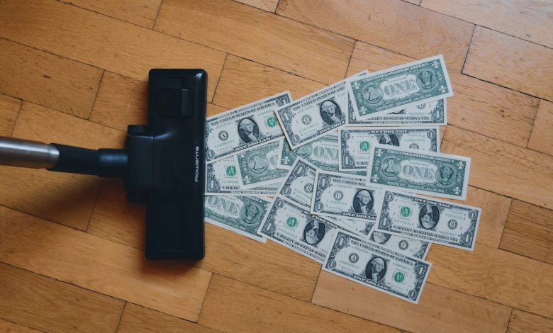 a pile of money sitting on top of a wooden floor