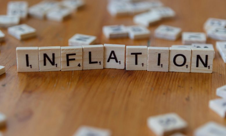 Inflation is spelled out using scrabble tiles.