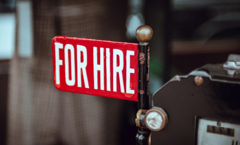 shallow focus photography of red and white for hire signage