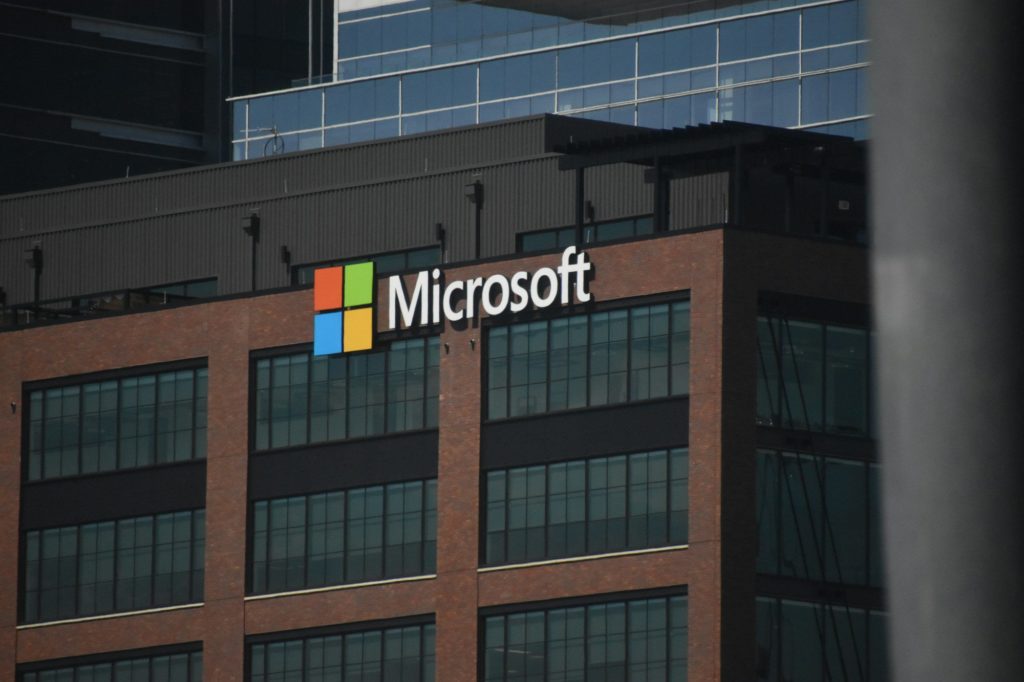 A tall building with a microsoft logo on top of it