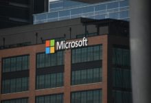 A tall building with a microsoft logo on top of it