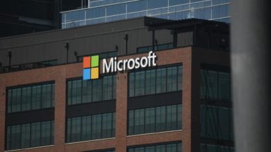 A tall building with a microsoft logo on top of it