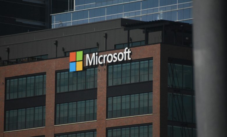 A tall building with a microsoft logo on top of it