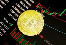 gold round coin on black surface