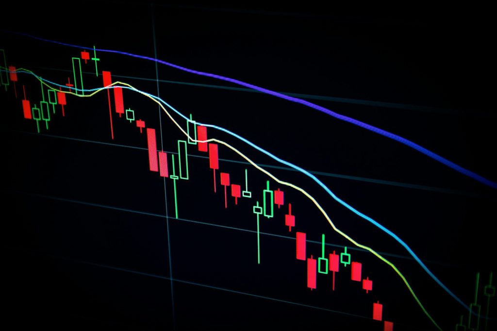 stock market candlestick chart on dark screen